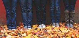 feet standing on autumn leaves